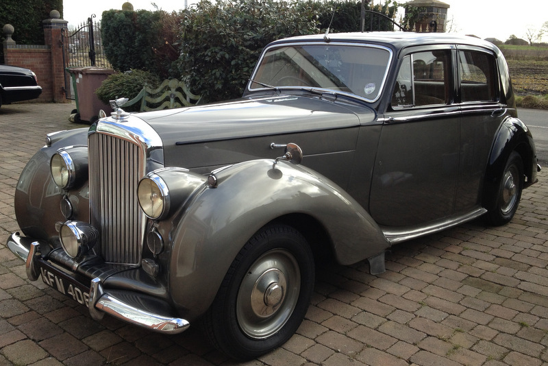 Chauffeur opening the Bentley door